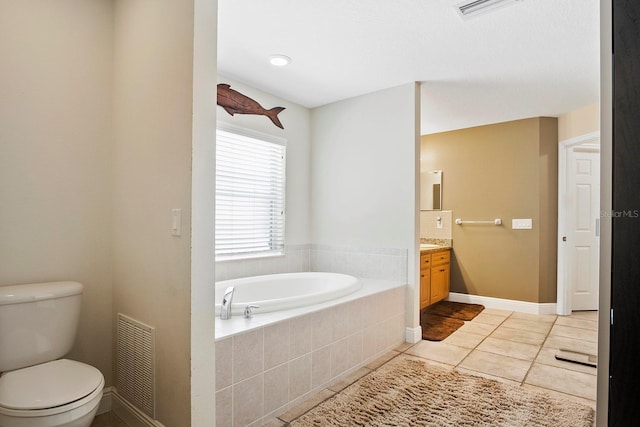 bathroom featuring vanity, toilet, tiled tub, and tile patterned floors