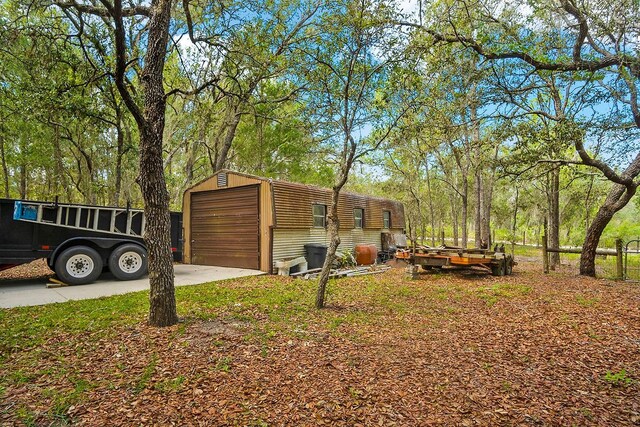 view of side of property with a garage and an outbuilding