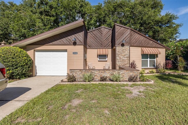 ranch-style home with a garage and a front yard