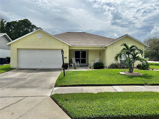 4713 Tiburon Dr, New Port Richey, FL 34655 - ranch-style home with brick siding, a shingled roof, driveway, a front yard, and an attached garage
