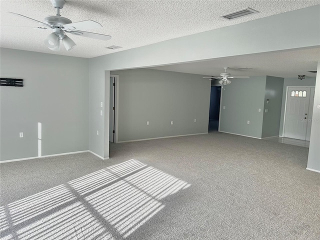 4713 Tiburon Dr, New Port Richey, FL 34655 - spare room with visible vents, ceiling fan, carpet floors, and a textured ceiling