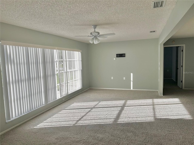 4713 Tiburon Dr, New Port Richey, FL 34655 - carpeted empty room featuring a ceiling fan, visible vents, a textured ceiling, and baseboards