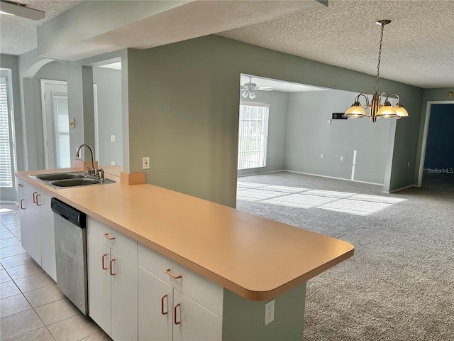 4713 Tiburon Dr, New Port Richey, FL 34655 - kitchen with a sink, a textured ceiling, dishwasher, and light carpet