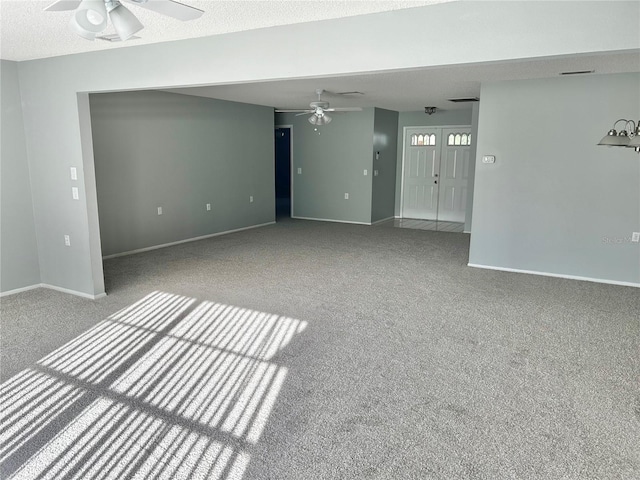 4713 Tiburon Dr, New Port Richey, FL 34655 - unfurnished living room with carpet flooring, ceiling fan, and baseboards