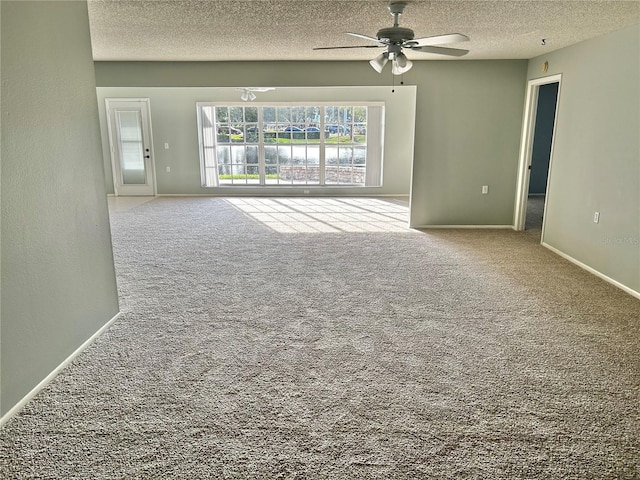 4713 Tiburon Dr, New Port Richey, FL 34655 - carpeted spare room featuring a textured ceiling, a ceiling fan, and baseboards