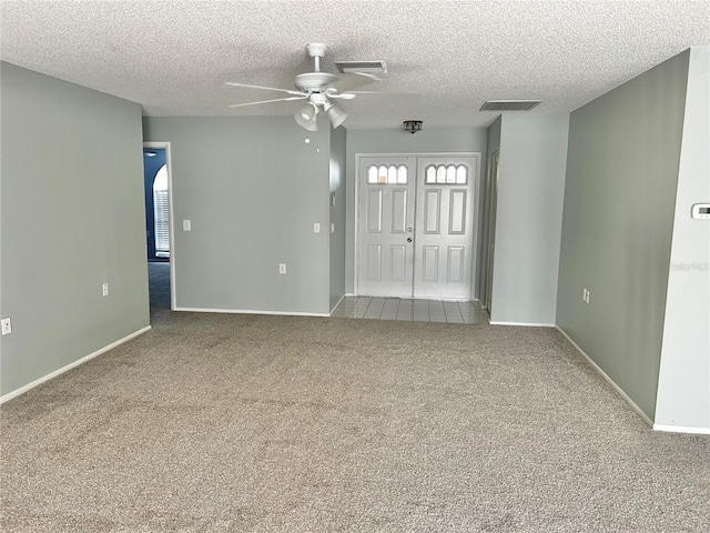 4713 Tiburon Dr, New Port Richey, FL 34655 - carpeted spare room with baseboards, visible vents, ceiling fan, and a textured ceiling