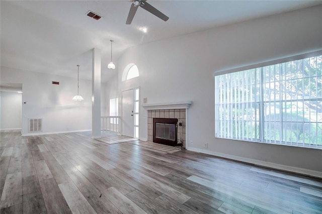 unfurnished living room with a fireplace, light hardwood / wood-style flooring, and ceiling fan