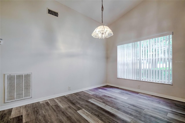 unfurnished room with a notable chandelier, high vaulted ceiling, and hardwood / wood-style floors