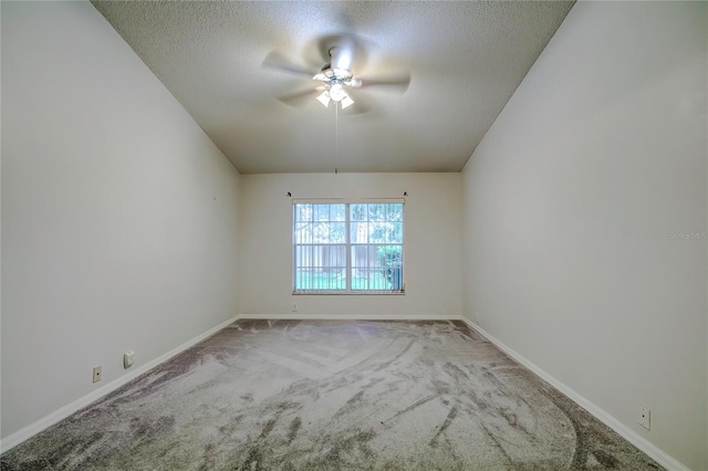 unfurnished room featuring ceiling fan, a textured ceiling, and light carpet