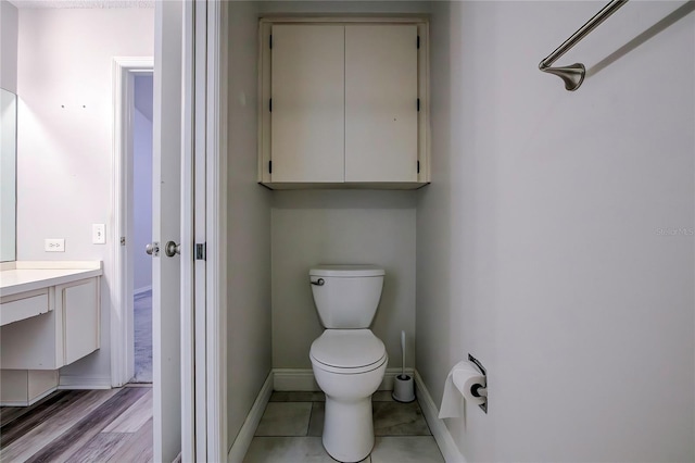 bathroom with toilet, tile patterned floors, and vanity