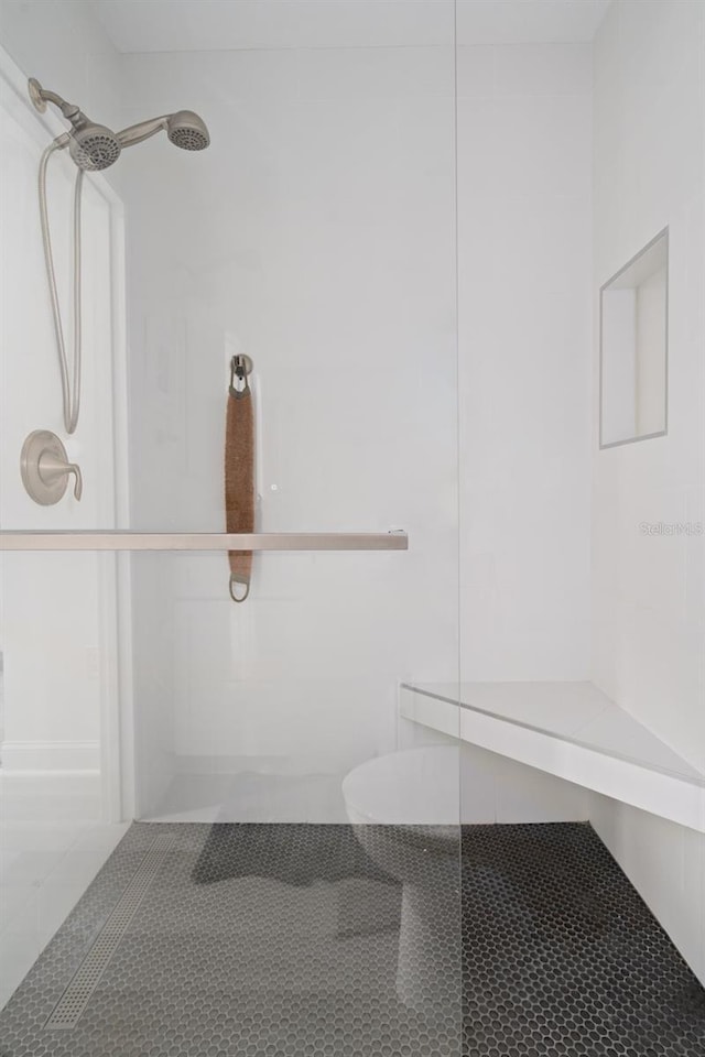 bathroom with tile patterned flooring and a shower