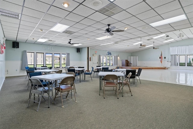 dining room featuring a drop ceiling, carpet floors, visible vents, and ceiling fan