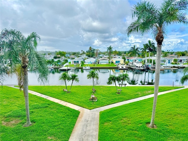 view of property's community featuring a yard and a water view