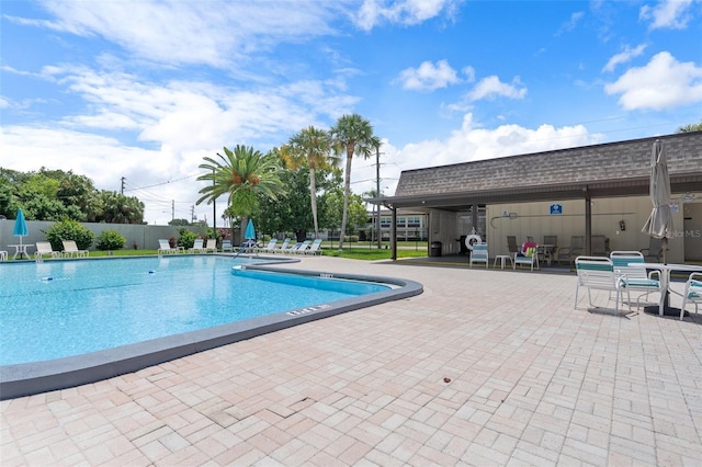 pool featuring a patio and fence