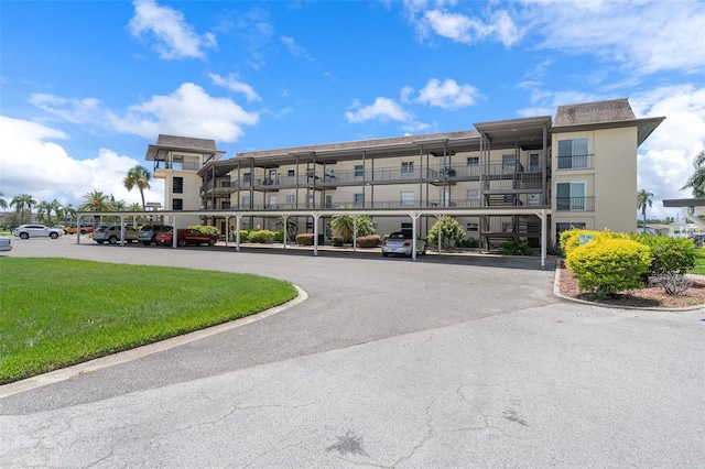 4632 Marine Pkwy Unit 302, New Port Richey, FL 34652 - view of apartment building / complex featuring covered parking