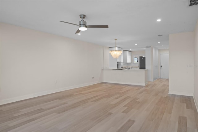 4632 Marine Pkwy Unit 302, New Port Richey, FL 34652 - unfurnished living room with light wood-style floors, a chandelier, recessed lighting, ceiling fan, and baseboards