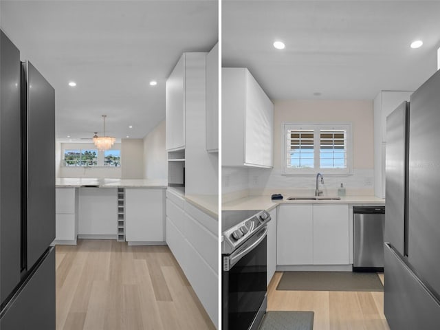 4632 Marine Pkwy Unit 302, New Port Richey, FL 34652 - kitchen featuring appliances with stainless steel finishes, a sink, light wood-style floors, white cabinetry, and recessed lighting