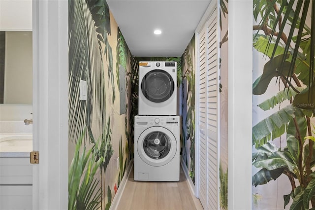 4632 Marine Pkwy Unit 302, New Port Richey, FL 34652 - laundry room featuring stacked washing machine and dryer, wood finished floors, and recessed lighting