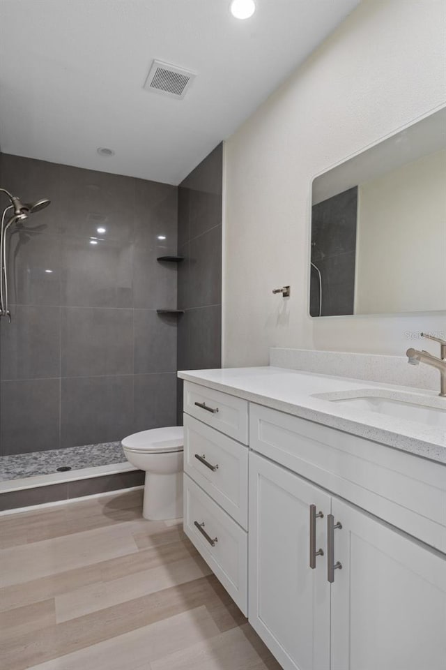 4632 Marine Pkwy Unit 302, New Port Richey, FL 34652 - full bath with vanity, tiled shower, toilet, wood finished floors, and recessed lighting