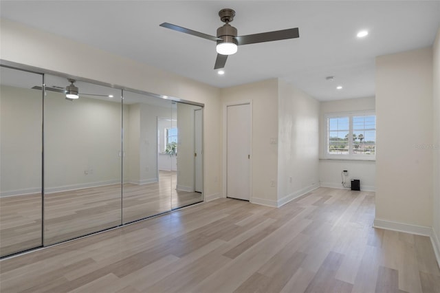 4632 Marine Pkwy Unit 302, New Port Richey, FL 34652 - unfurnished bedroom featuring light wood finished floors, baseboards, recessed lighting, and a ceiling fan