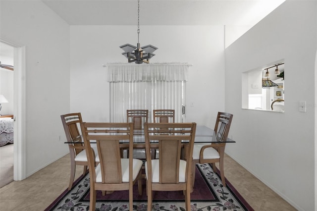 dining space with tile patterned flooring and a notable chandelier