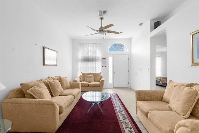 living room with ceiling fan and light tile patterned floors