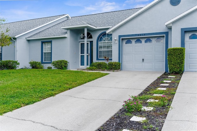 single story home featuring a garage and a front lawn