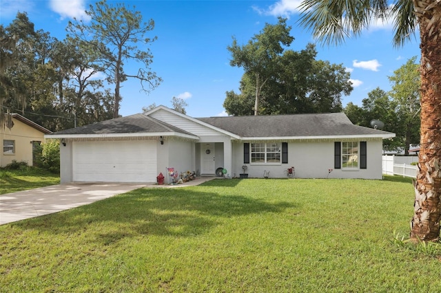 single story home with a garage, fence, concrete driveway, stucco siding, and a front yard