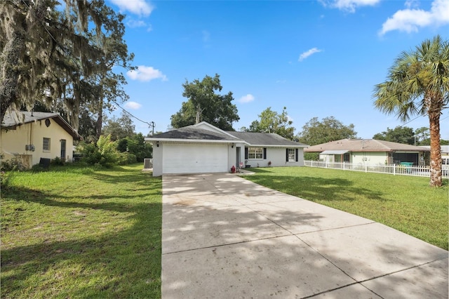 ranch-style house with stucco siding, fence, a garage, driveway, and a front lawn