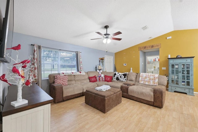 living room featuring ceiling fan, light hardwood / wood-style flooring, and lofted ceiling