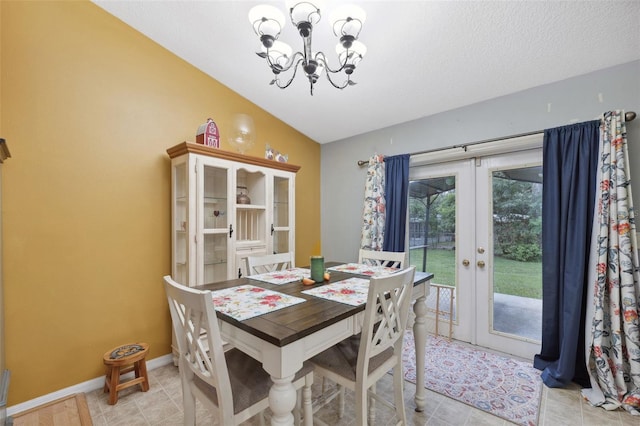 dining room featuring light tile patterned floors, vaulted ceiling, french doors, and a chandelier