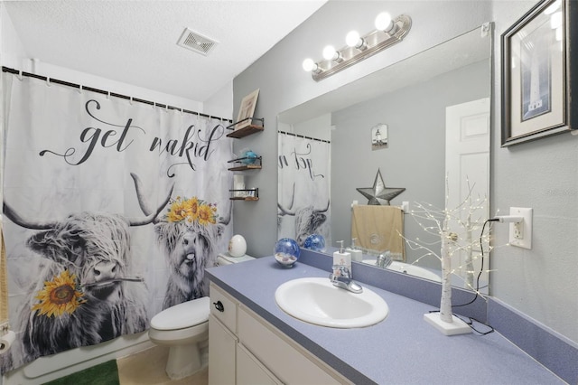 bathroom featuring vanity, toilet, a textured ceiling, and tile patterned flooring