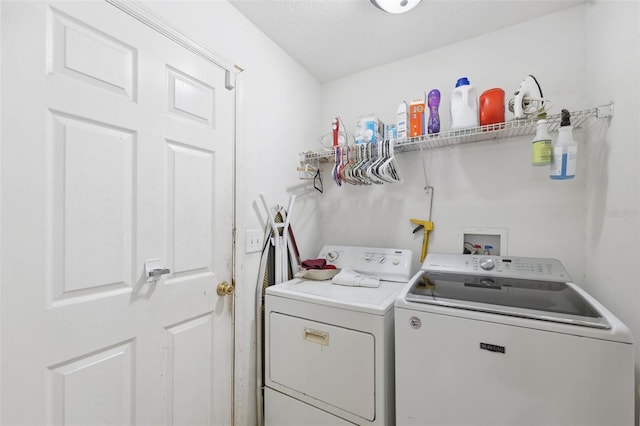 clothes washing area with independent washer and dryer