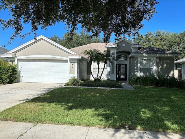 view of front of house featuring a garage and a front yard