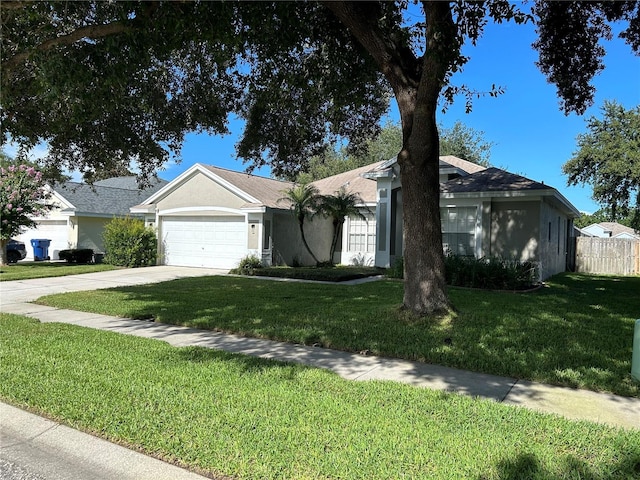 single story home with a garage and a front lawn