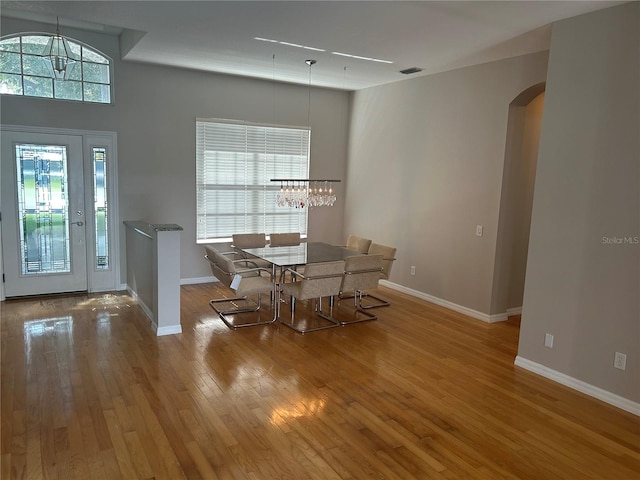 dining space with wood-type flooring