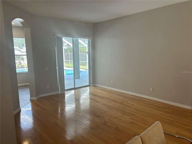 unfurnished room with hardwood / wood-style floors