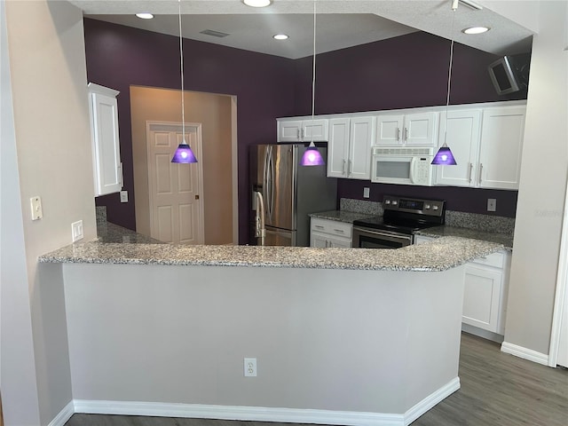 kitchen featuring white cabinetry, wood-type flooring, light stone counters, appliances with stainless steel finishes, and kitchen peninsula