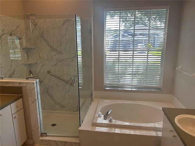 bathroom featuring vanity and shower with separate bathtub