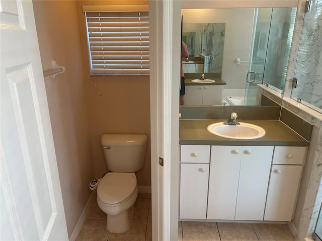 bathroom with tile patterned flooring, toilet, and vanity