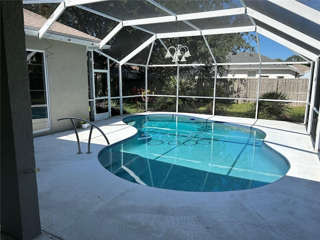 view of swimming pool with a patio and glass enclosure