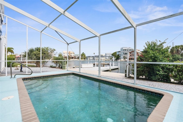 view of swimming pool with a boat dock and glass enclosure