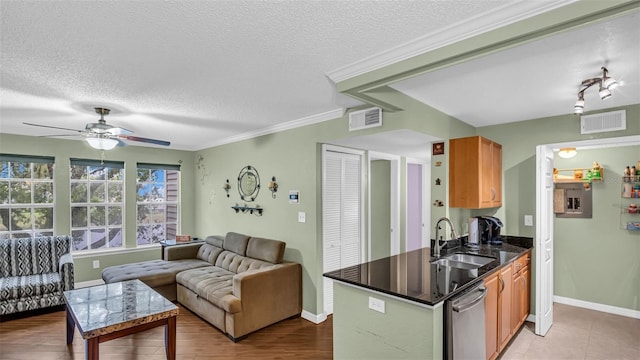 kitchen with ceiling fan, ornamental molding, sink, dishwasher, and light tile patterned floors