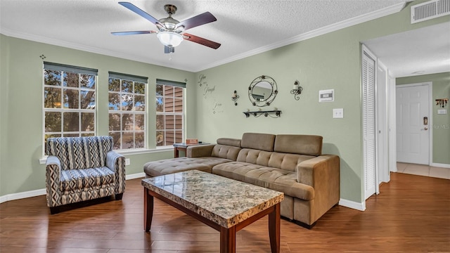 living room with ornamental molding, a textured ceiling, ceiling fan, and hardwood / wood-style floors