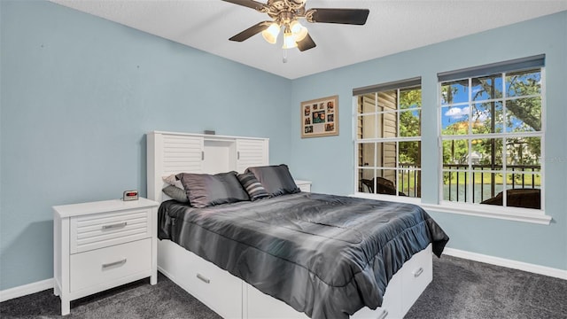 bedroom featuring dark colored carpet and ceiling fan