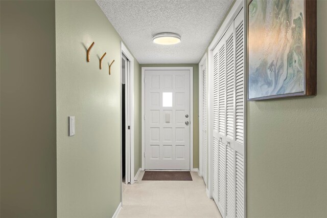 entryway with a textured ceiling