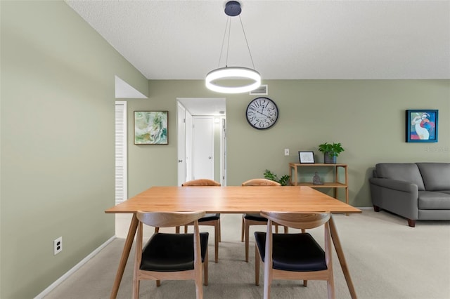 dining space featuring carpet