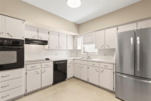 kitchen featuring sink, a textured ceiling, black appliances, and light tile patterned floors