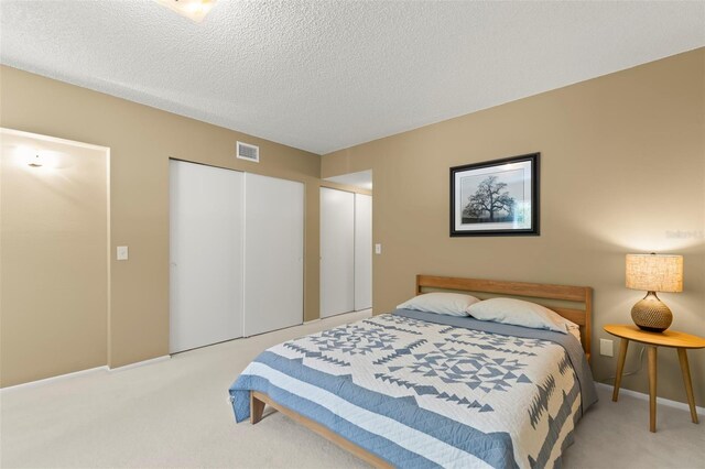 carpeted bedroom featuring a textured ceiling