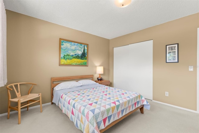 carpeted bedroom featuring a textured ceiling